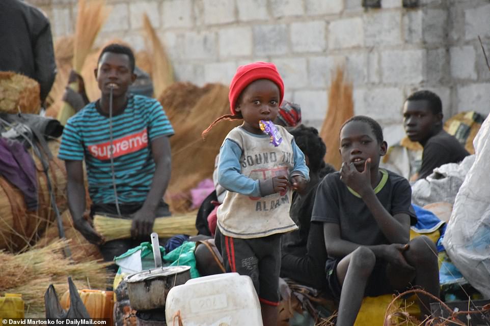Sound the alarm: In another slum, Buseko Market, parentless teens raise parentless children on the street – where they sleep on fanned-out bundles of dried tall grass and make brooms from them to sell after they wake up
