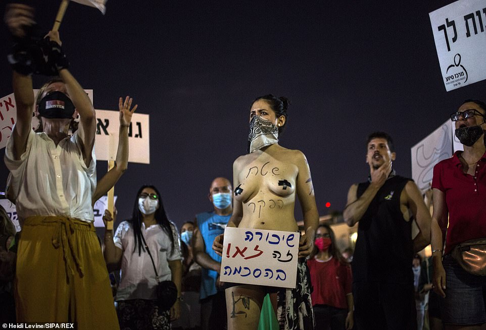 Protestors have taken to the streets in cities across Israel to express their outrage at the news that a 16-year-old girl was allegedly gang raped by up to 30 men who queued outside a hotel room, waiting their turn. Pictured: Protestors gather in Tel Aviv