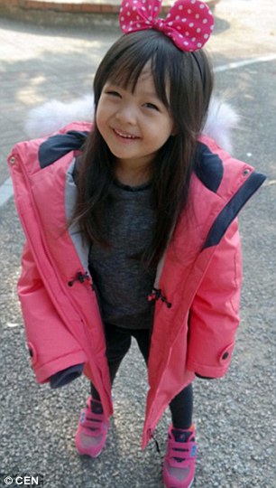 Jae-eun sports a giant pink bow in her hair and an adorable rain jacket as she poses for a picture