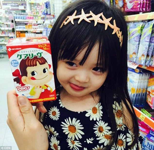 Posing in a daisy-print dress and starfish headband, Jae-eun pokes out her tongue to mimic a character on food packaging 