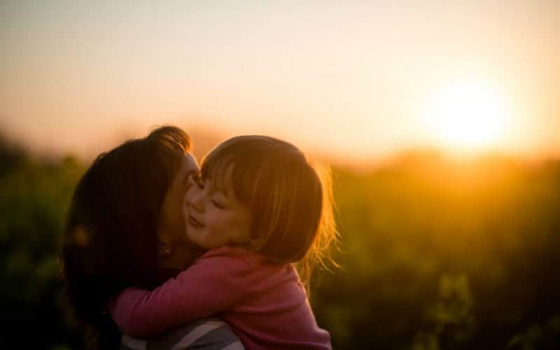 a mother hugging her toddler in the sunset, family rules make loving families