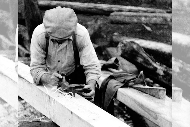 Carpenter woodworking with a plow plane