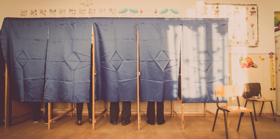 People voting in a classroom.