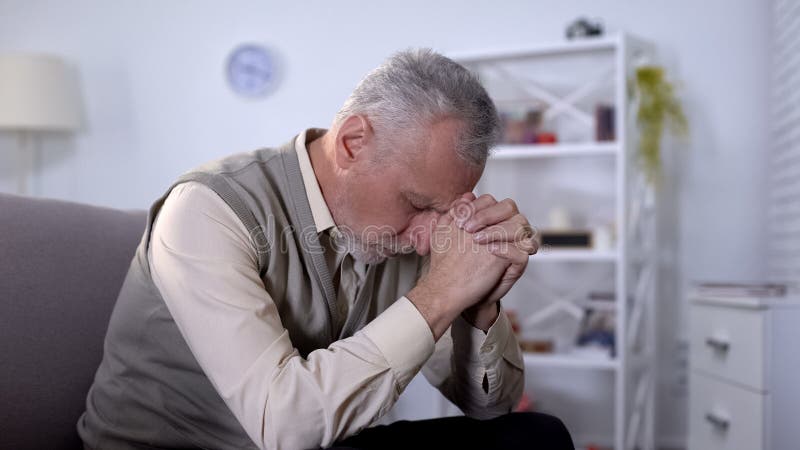 Elderly man sadly bowed head, feeling lonely and depressed, old age crisis. Stock photo royalty free stock photography