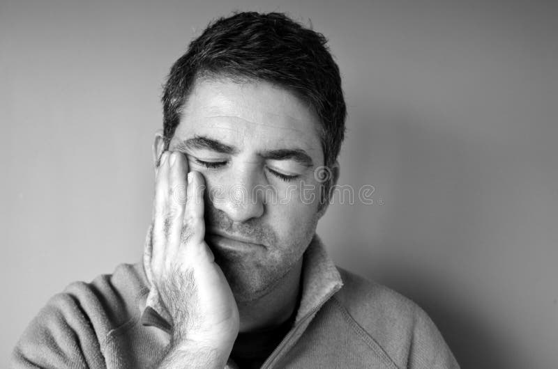 Middle age man crisis concept. Portrait of a sad man (age 40-45) holds his hand on his face in sorrow. Middle age crisis concept. real people copy space (BW stock photography