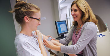 Dr. Tate gives a study participant an armband to monitor activity levels.