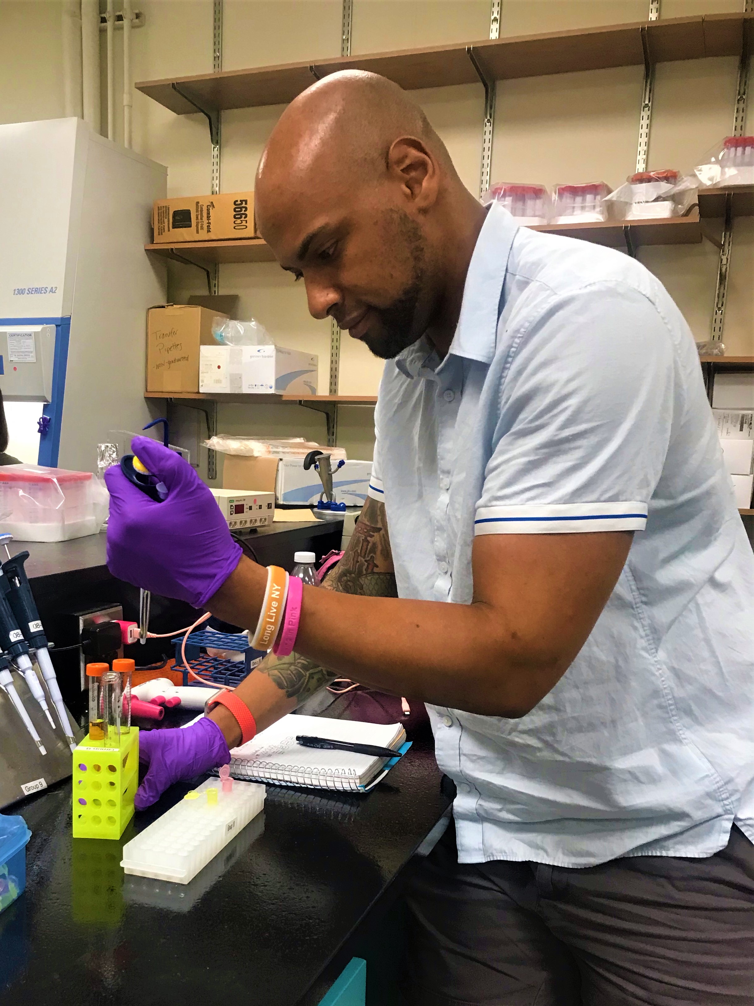 Queensborough undergraduate researcher and summer intern, Adam McConnell, using pipette in the lab.