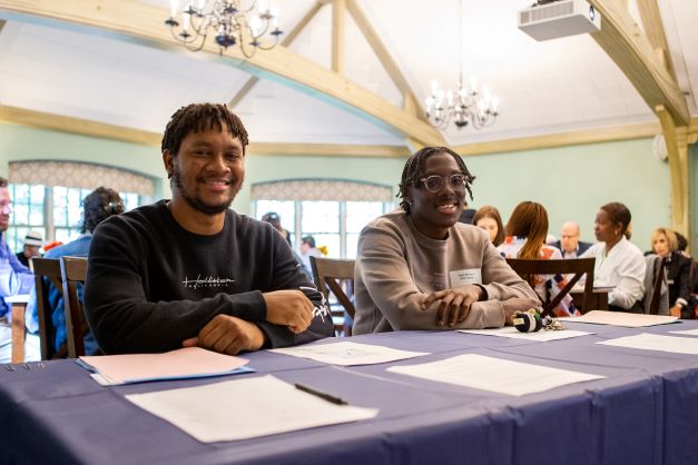 Shameir Nembhard and Elijah Bernard assisting with check in