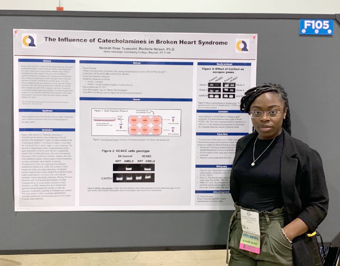 Hannah Rose Toussaint next to Biology Presentation Poster