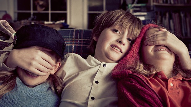Three kids watching a scary movie
